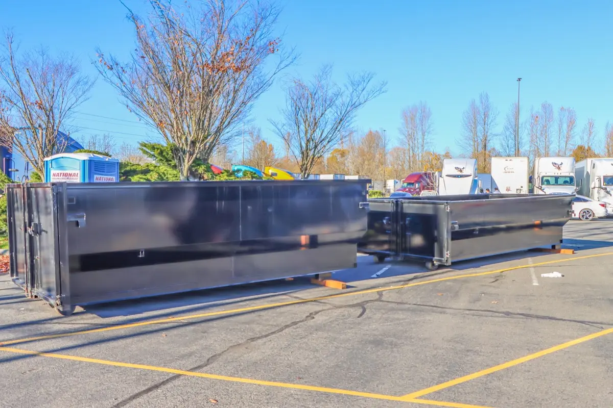 Professional dumpster rental service with roll-off container on residential driveway in Edna